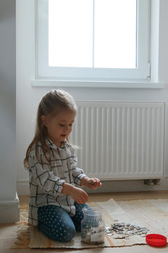 Girl counting coins in moneybox