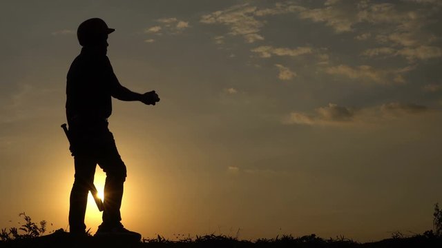 Silhouette of baseball player play baseball on sunset,Thailand people