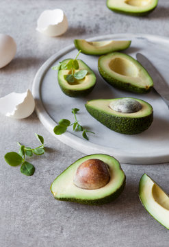 Sliced avocado and egg shells