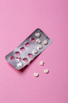 Pills blister pack on pink background
