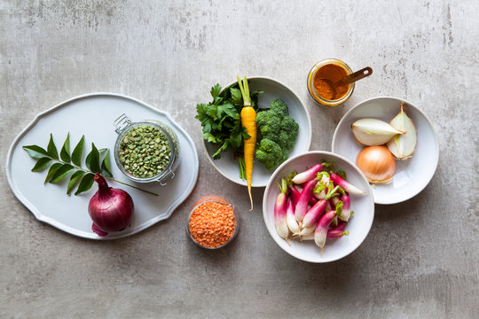 Variety of vegetables, spices and pulses on kitchen table