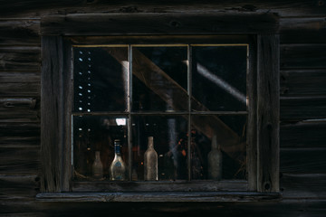 old bottles in a barn window