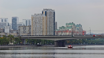 Moscow district on Nagatinskaya Embankment on Summer day, view on Moscow River water, Bridge and new buildings houses