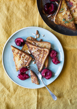 Delicious french toast with roasted plums and almond nuts
