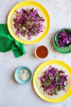 Vegan black bean tacos with cabbage slaw, mushrooms, sesame seeds and cilantro