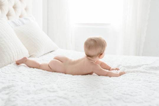A Little Baby's Bottom On A Simple Bed