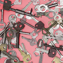 Keys set on pink background. Door lock keys and safes for proper