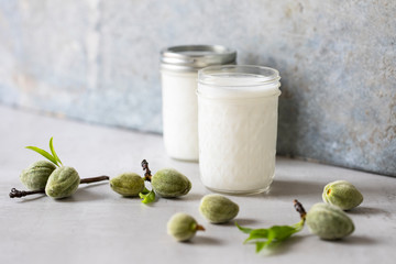 Raw almond milk with scattered fresh almonds