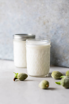 Raw almond milk with scattered fresh almonds