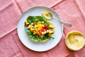 Healthy salad vegan lettace cups filled with mango chickpea salad and curry tahini