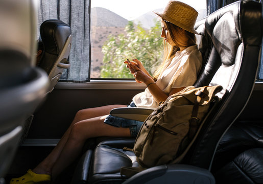 Woman using phone in bus