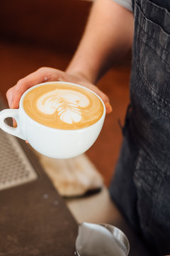 Barista serves a cappuccino.