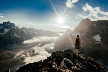 Man on rocky cliff above amazing valley
