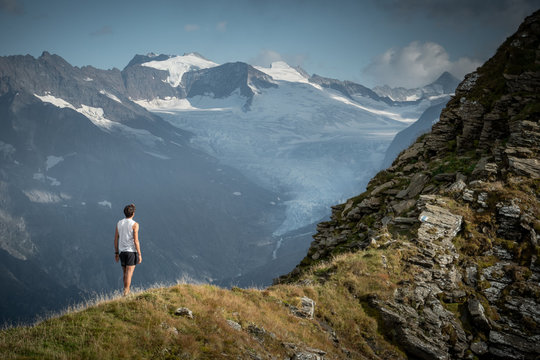 athlete in front of swiss alps glacier