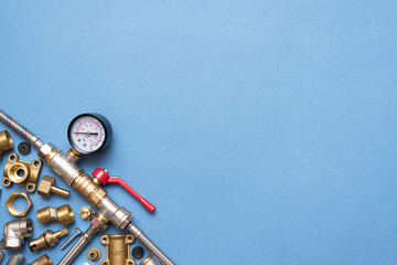 Plumbing flat lay background with copy space. Work tools and pipeline parts on plumber workbench.
