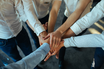 group of business people joining hands