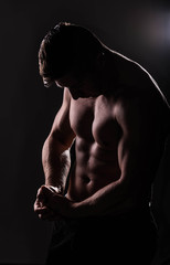 Fototapeta na wymiar Strong Athletic Man Fitness Model Torso showing big muscles over.