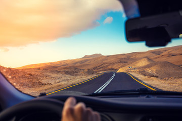 Driving a car on a mountain road. Desert landscape. Journey by car. View from the car of a mountain...