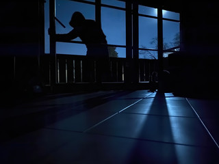 Burglar with at night entering  house