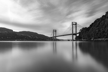 Long exposure, silk effect in Rande bridge on sunset landscape in black and white, Puente de Rande, Rande, Vigo, Pontevedra, Galicia, Spain