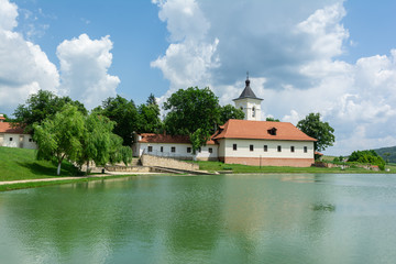 Obraz premium Lake in front of the entrance to Capriana Monastery, Republic of Moldova