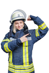 Portrait of young firefighter woman in helmet and wears an uniform, looking at camera and showing her biceps