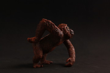 orangutan shaped plastic toy in color background