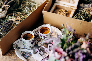 Valentines day romantic dinner table setting marry me wedding engagement ring in box with lavender gift cup of coffee surprise on pink background with copyspace. Love flower gift woman making proposal