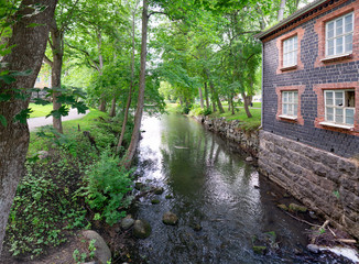 The beautiful summer day in Fiskars Village, Raasepori, Finland. The river is flowing gently and the birds are singing.