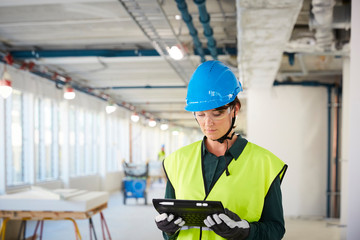 Engineer using digital tablet at construction site