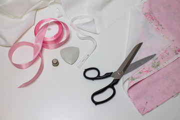 Materials and accessories for handmade. The process of hand sewing with fabric, scissors, accessories for sewing.