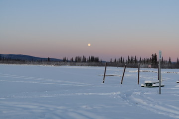 morning moon over frozen lake