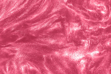 Abstract elegant, detailed pink glitter particles flow with shallow depth of field underwater....