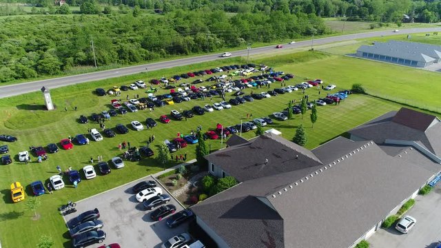 Ascending Drone Aerial Over Outdoor Exotic Car Show Lots Of People Walking Around