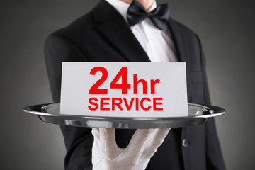 Waiter Holding Plate With The Text Thank You On Paper