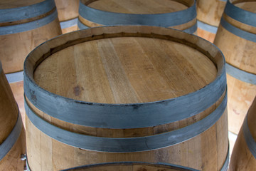 Wooden barrels stand on top of each other, wine storage, part of the interior, the structure of the tree.