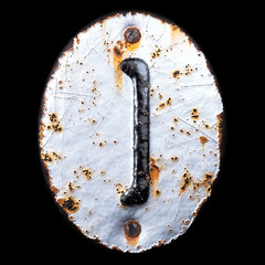 Symbol left brackets made of forged metal on the background fragment of a metal surface with cracked rust.