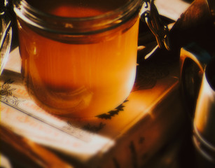 Honey in a glass cup on a book