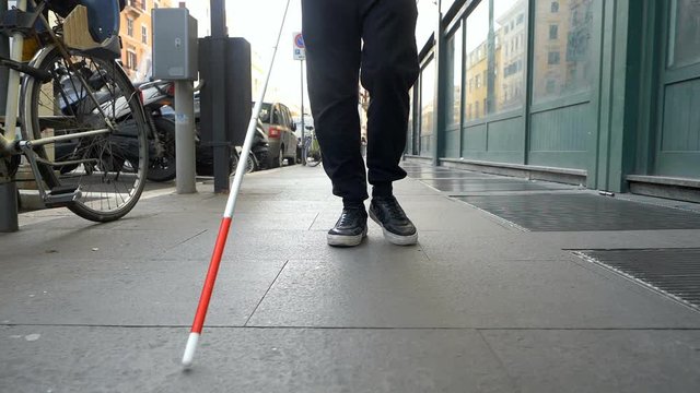 blindness,orientation,city.Blind man walking in the street with his stick