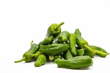 a bunch of green peppers isolated on white