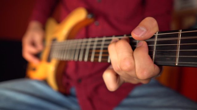 Close up of guitarist playing solo on guitar