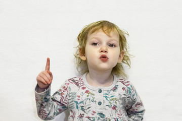 Little girl of three years old, looking at the camera and smiling.Defocused image.