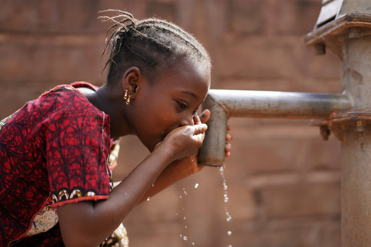 Beautiful Portrait of African Children Drinking Outdoors Fresh Water from tap
