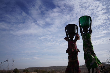 Panorama Shot of Couple of African Black Teenage Girls with Water Buckets