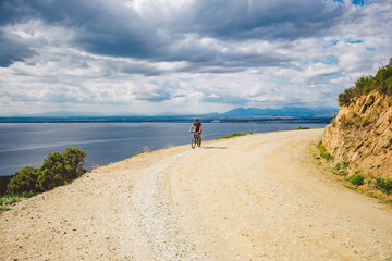 young guy riding a mountain bike on a bicycle route in Spain. Athlete on a mountain bike rides...