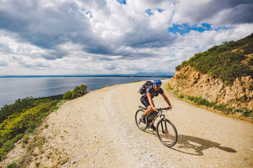 young guy riding a mountain bike on a bicycle route in Spain. Athlete on a mountain bike rides...
