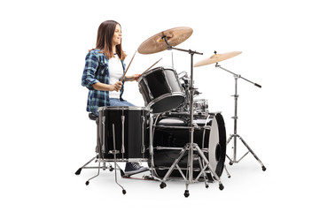 Fototapeta na wymiar Young female drummer playing a drum set