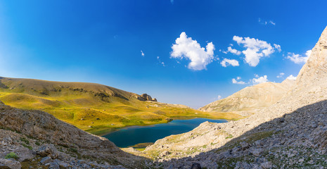 Amazing mountain lake between Bolkar Mountain and Taurus Mountain. Panoramic view of black lake. Nigde, Turkey. Volcanic crater. Travel background.