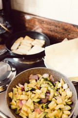 Zucchini, potatoes and onions stir-fried in a pan