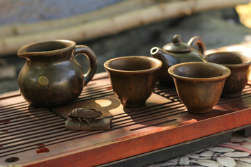 Tea ceremony. Teapot and bowls with Chinese tea on a wooden table. Drink, traditional, japan, health, beads, buddha, asia, asian, background, bamboo, beverage